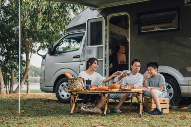 A joyous family enjoying a picnic in front of their RV, which they do not yet know is a lemon vehicle that is eligible for the Tennessee Lemon Law.